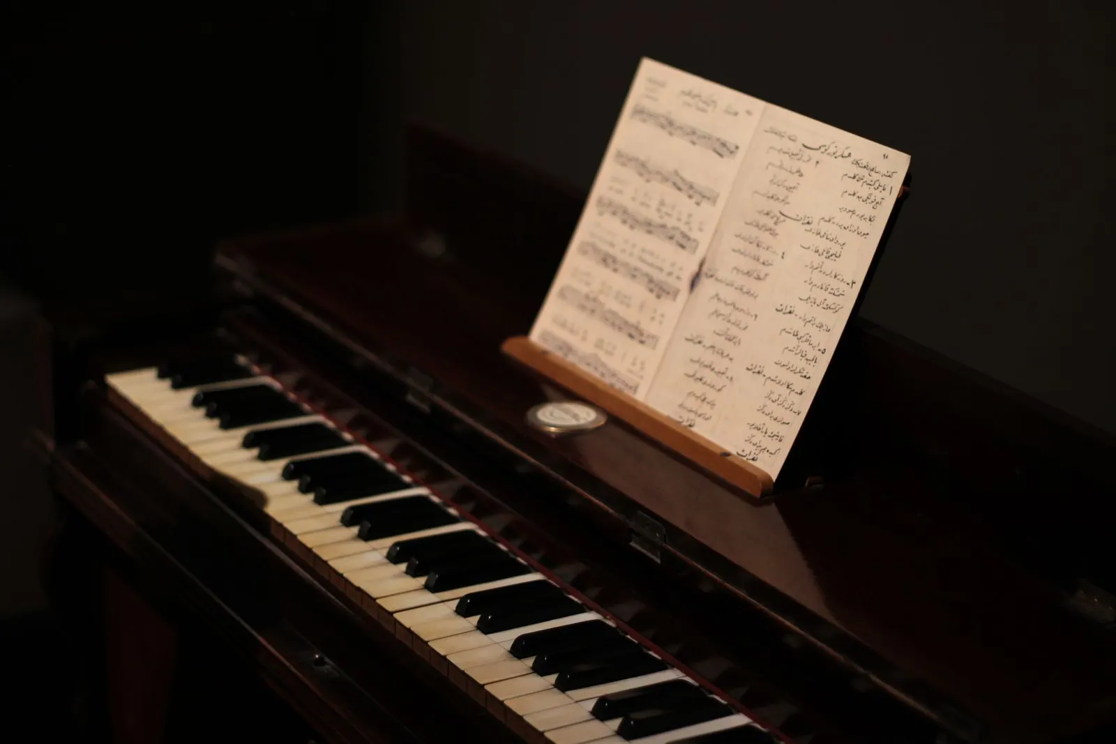 A close-up of a vintage piano with sheet music, highlighting its nostalgic charm.
